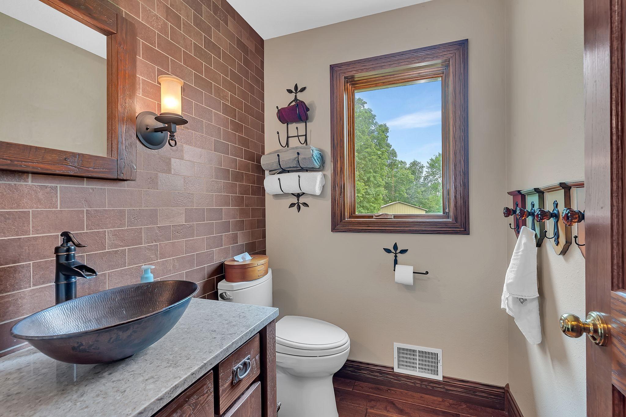 1/2 bath with real brick tile & vessel bowl copper sink