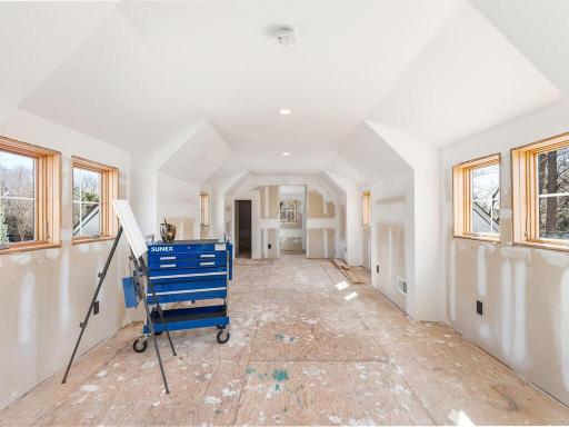 Unfinished bonus space above the garage with dormers and a bathroom rough-in offers a rare, ready-to-finish opportunity for a private guest suite, studio, or custom living space.