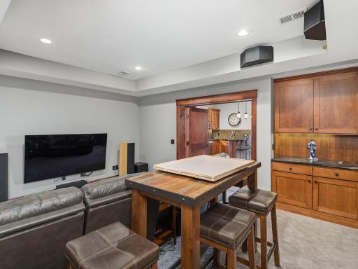 Private, fully enclosed 7.1 surround sound theater with custom cabinetry, 4K 75" Samsung display, and dedicated A/V storage for a true at-home cinema experience.