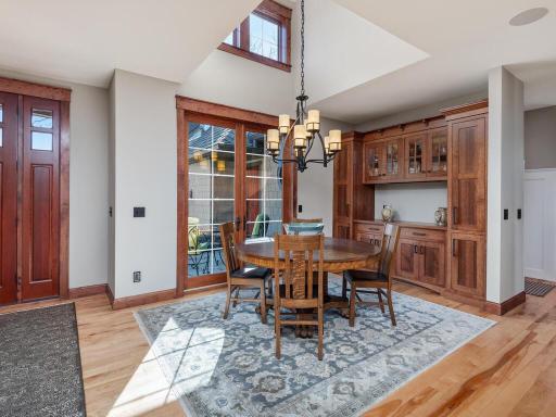 Dining Area with French Doors, beautiful custom quartersawn oak cabinetry, and ample nature light.