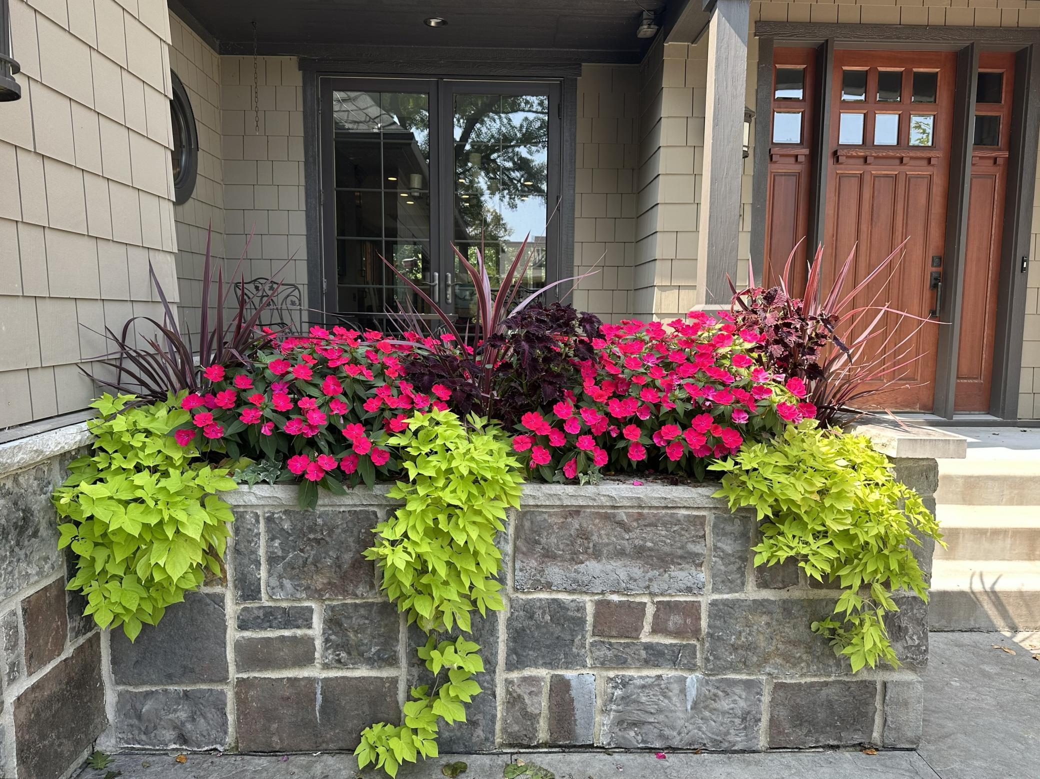 Custom stone planter box with irrigation & drainage system.