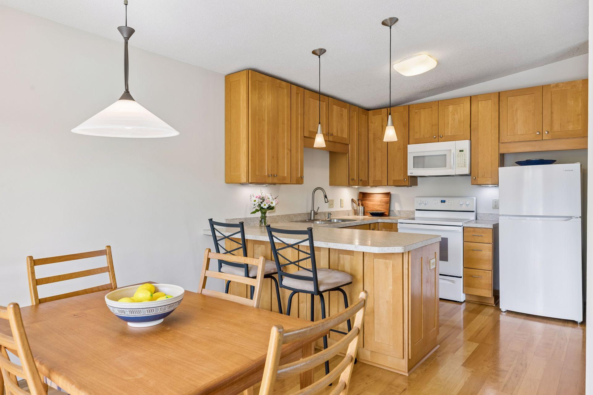 Wonderfully updated kitchen with custom cabinets, lighting, flooring and counters