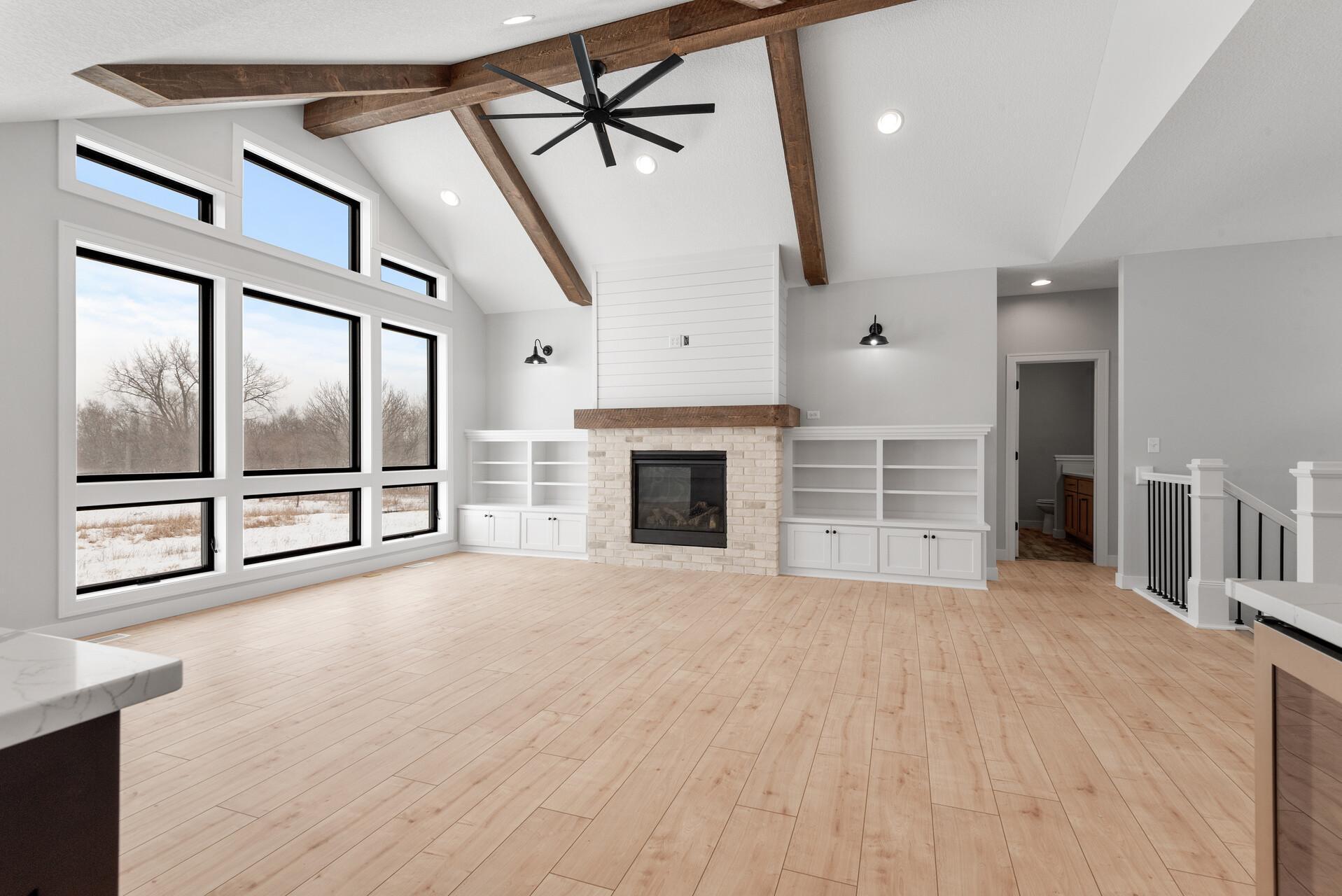 Stunning Vaulted Great Room w/ Beams, Fireplace, Built-Ins and Bold Window Layout! Photo of previous home.