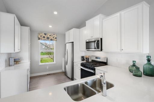 This showcase kitchen layout is highlighted with natural light due to large kitchen window. *Picture is of model home; actual finishes may vary.