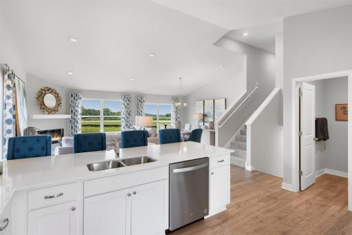 Kitchen peninsula provides a great place for informal meals and gathering. *Picture is of model home; actual finishes may vary.