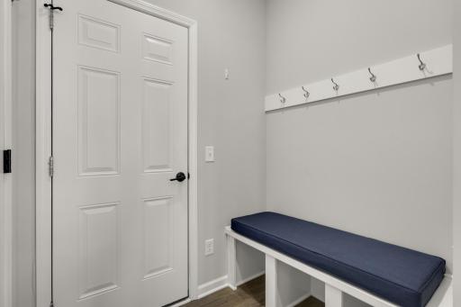 Built in bench and hooks near door to the garage.