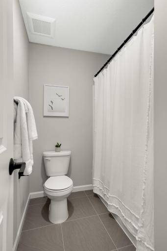 In the hallway bathroom, the sink/vanity area is separated from the toilet and tub/shower with a pocket door.