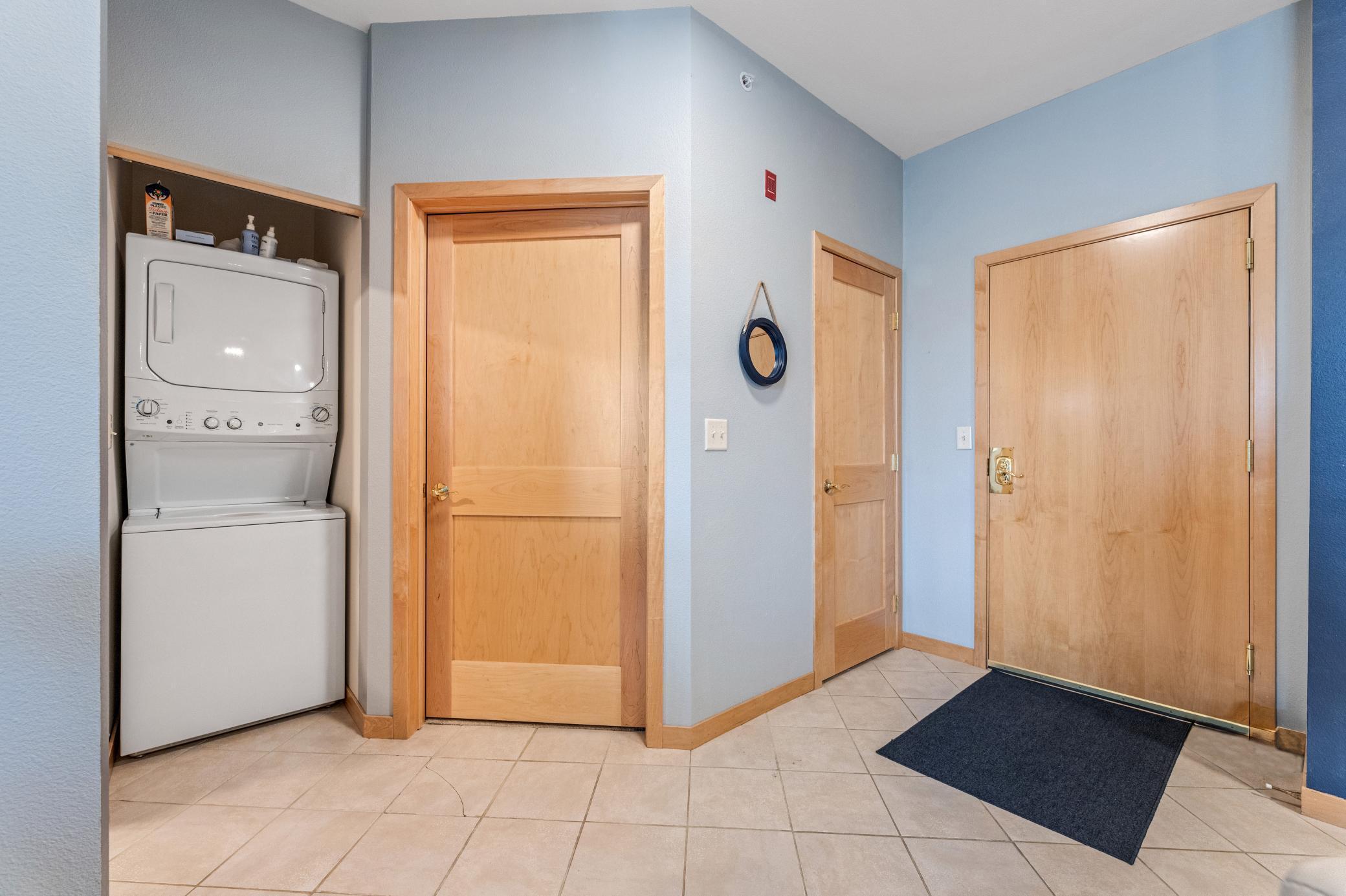 foyer and laundry closet with BRAND NEW stackable washer and dryer