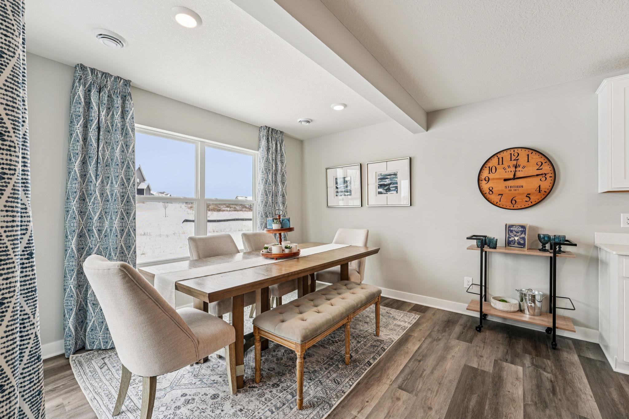 One of the highlights of the Princeton home being the dining area has a 'sunroom' feel to it! Lots of windows and natural light, easy access to your private patio on the rear of your home! Photo of model home, color & options will vary.