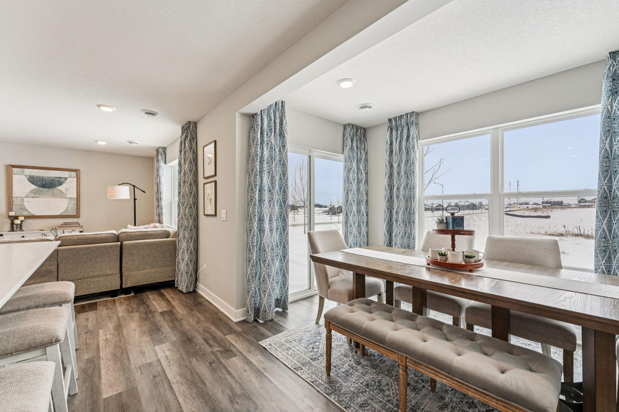 One of the highlights of the Princeton home being the dining area has a 'sunroom' feel to it! Lots of windows and natural light, easy access to your private patio on the rear of your home! Photo of model home, color & options will vary.