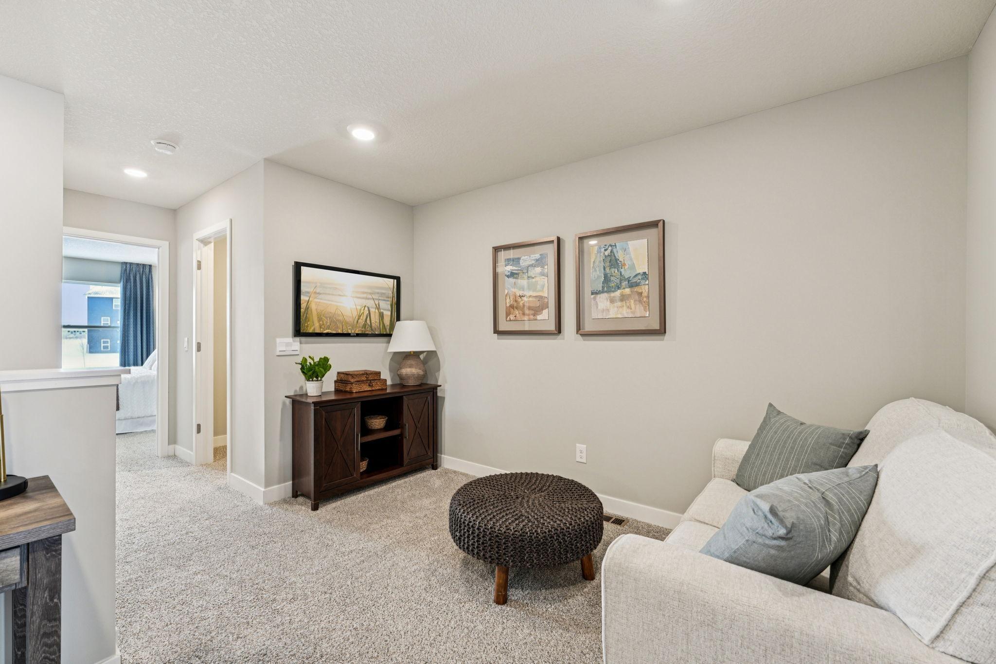 Once upstairs, the entire level flows from the focal point of this loft space. Sure to become a family favorite hangout spot, the room is centrally located from each of the home's upper level bedrooms! Photo of model home, color & options will vary.