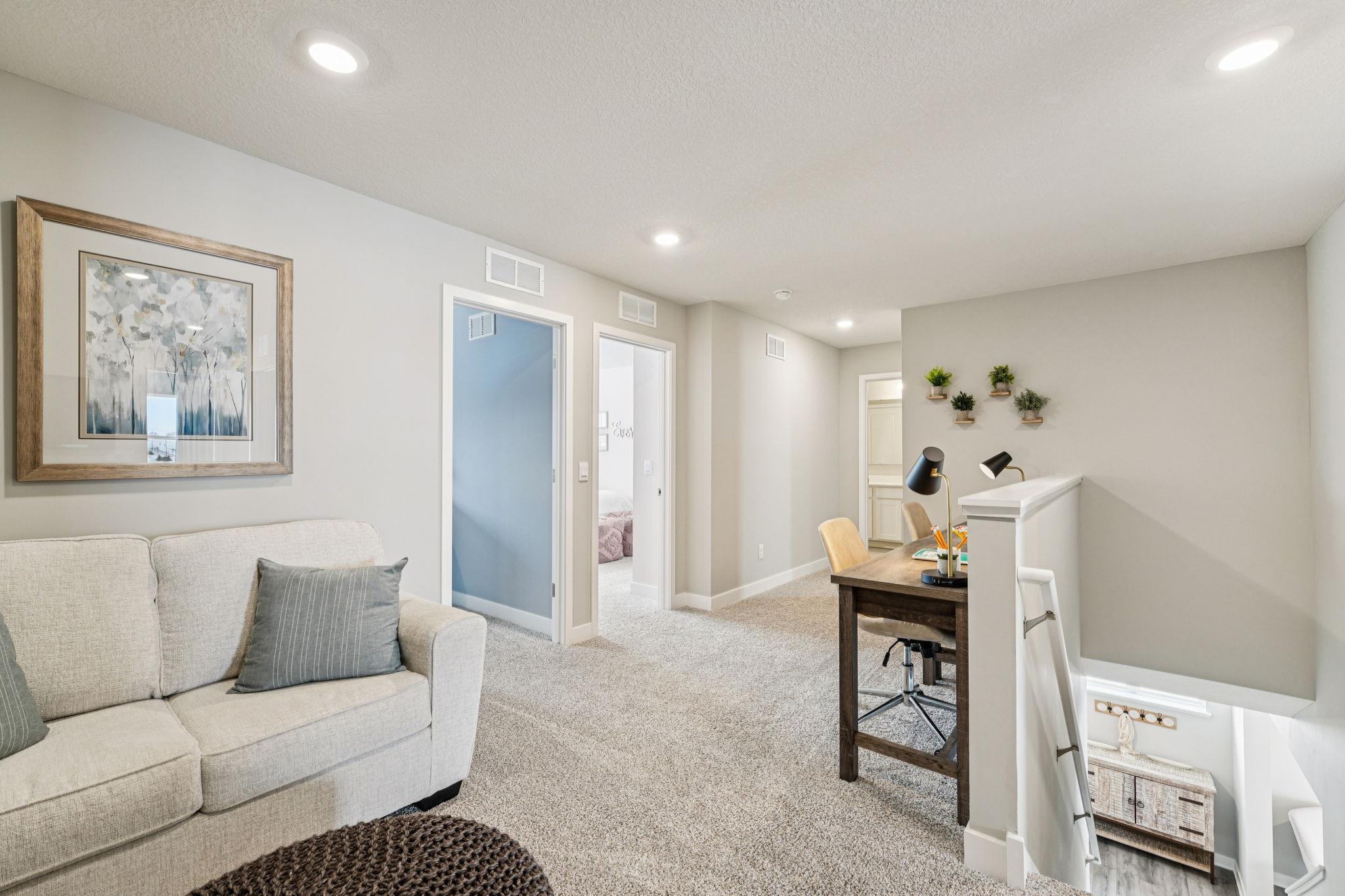 Once upstairs, the entire level flows from the focal point of this loft space. Sure to become a family favorite hangout spot, the room is centrally located from each of the home's upper level bedrooms! Photo of model home, color & options will vary.