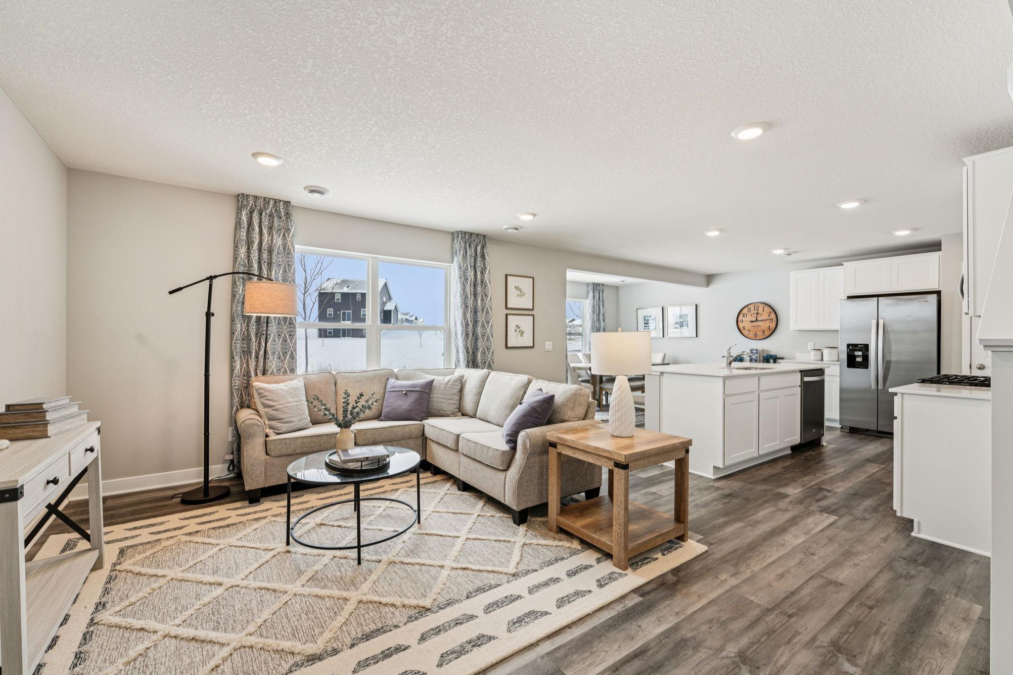 With the kitchen flowing into the dining and living room, it makes for a great gathering space for family & friends. Photo of model home, color & options will vary.