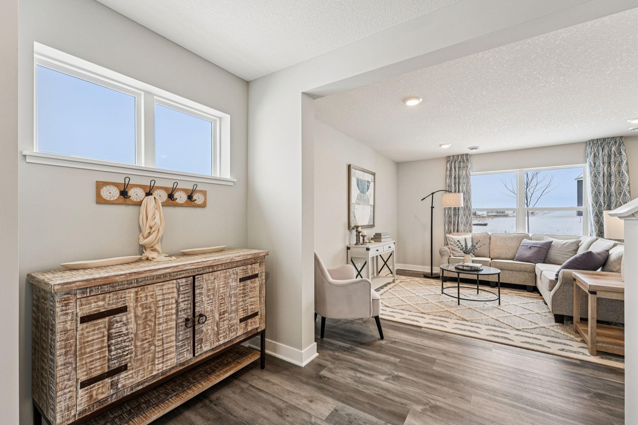 At the end of day, the living room provides a great space to kick up your feet and relax. Photo of model home, color & options will vary.