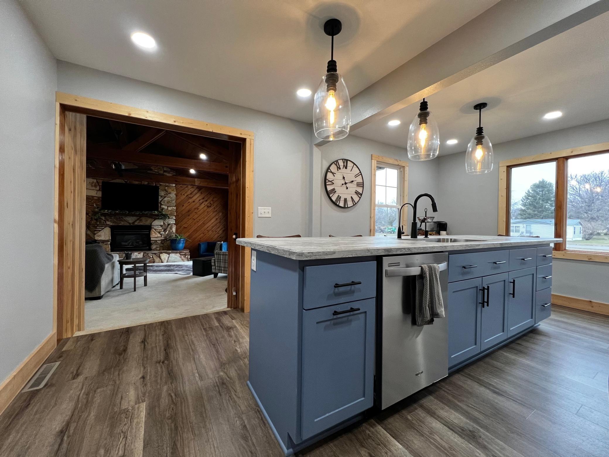 Blue Cabinets set off the center island along with Beautiful Pendant Lighting!