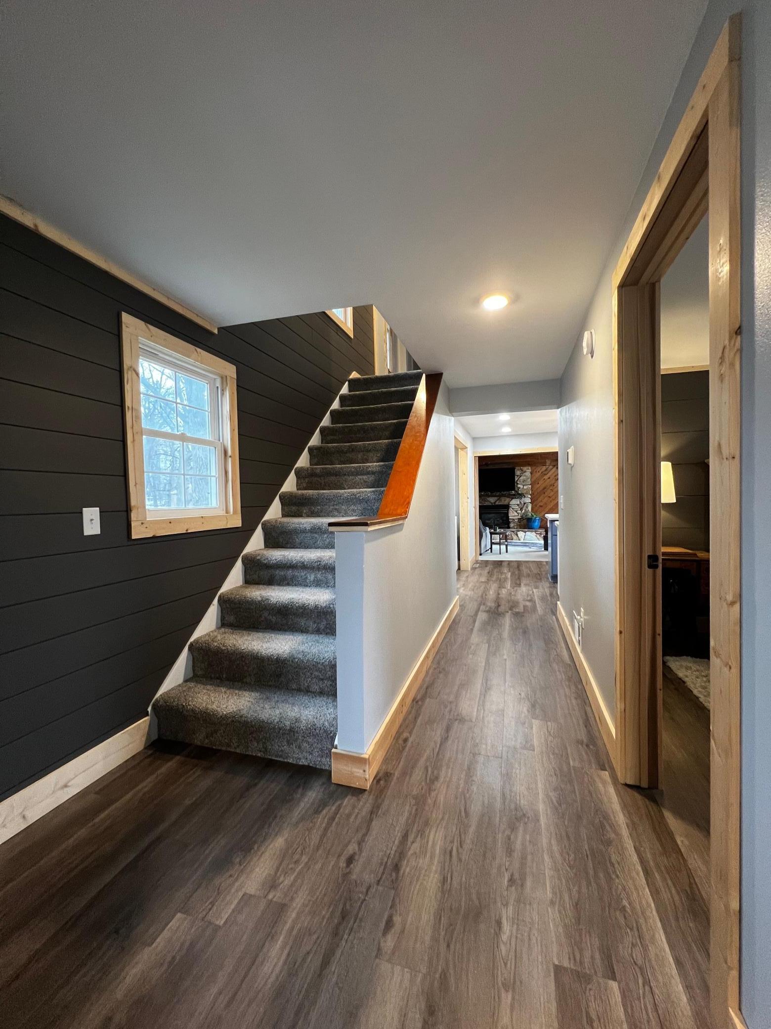 View of Stairway, Hall to Primary Bedroom, Kitchen & Living Room.