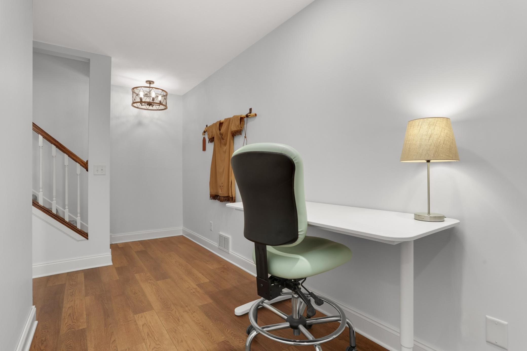 Lower-level landing with flexible open workspace.