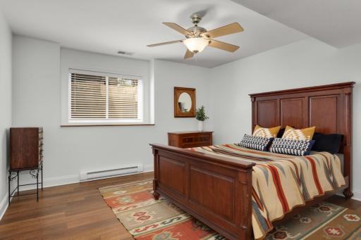 Lower-level bedroom with a window bringing in natural light.