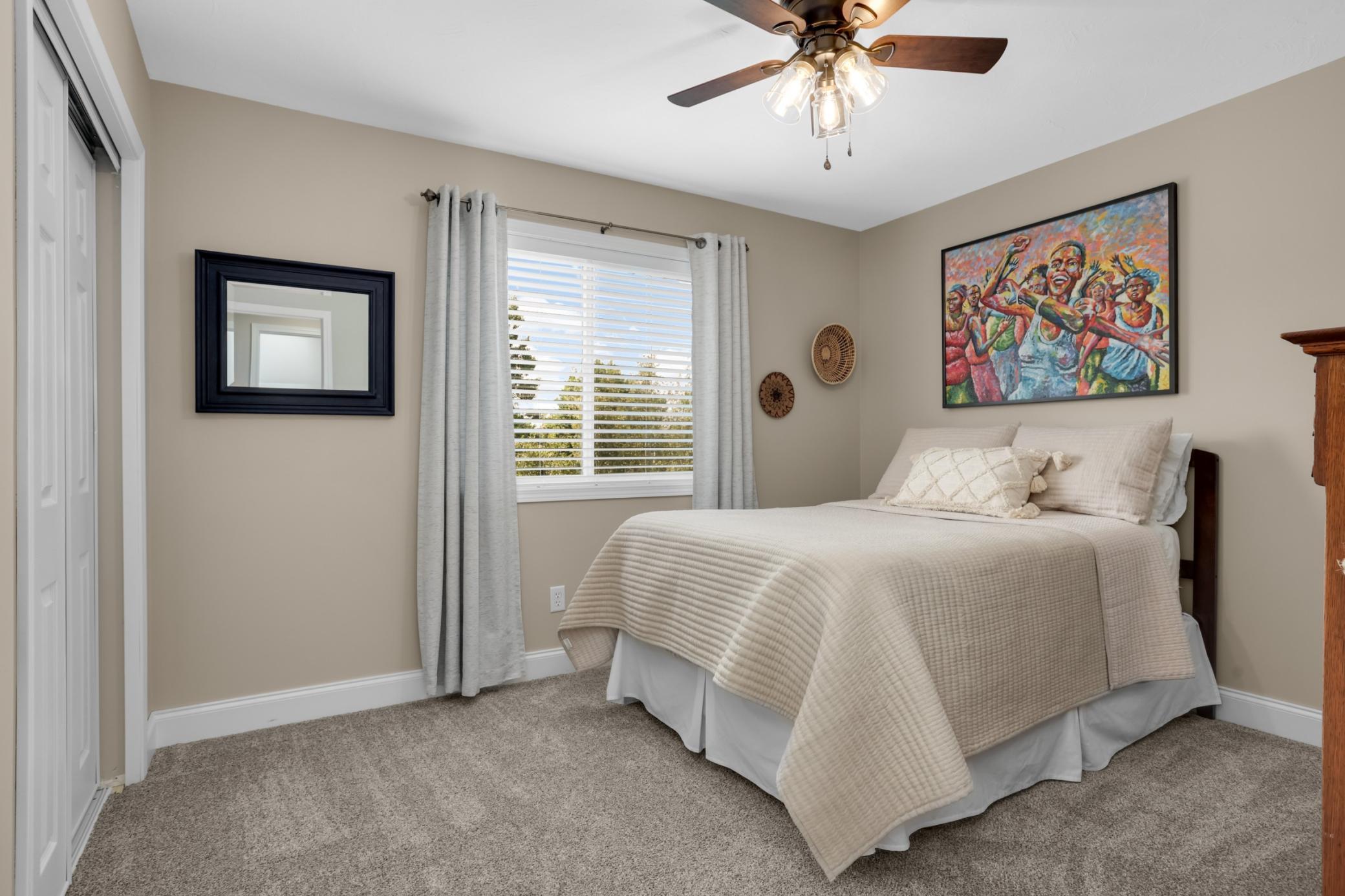 Upper-level bedroom overlooking the peaceful backyard.