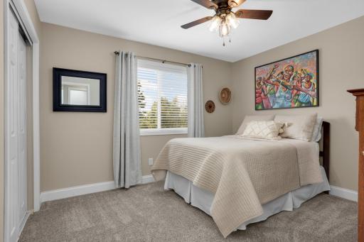 Upper-level bedroom overlooking the peaceful backyard.