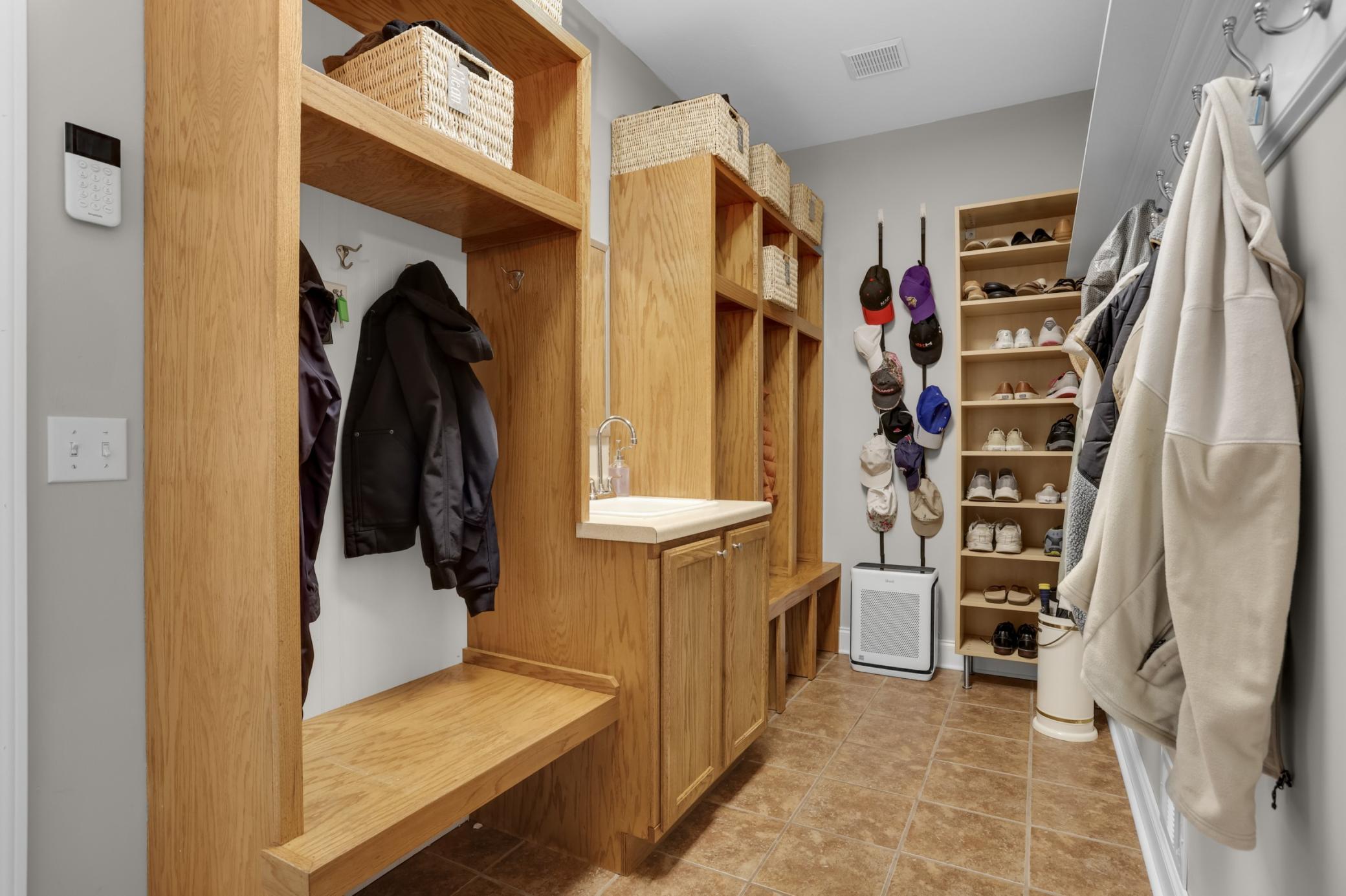 Mudroom with locker-style cubbies & utility sink, conveniently located just off the garage.