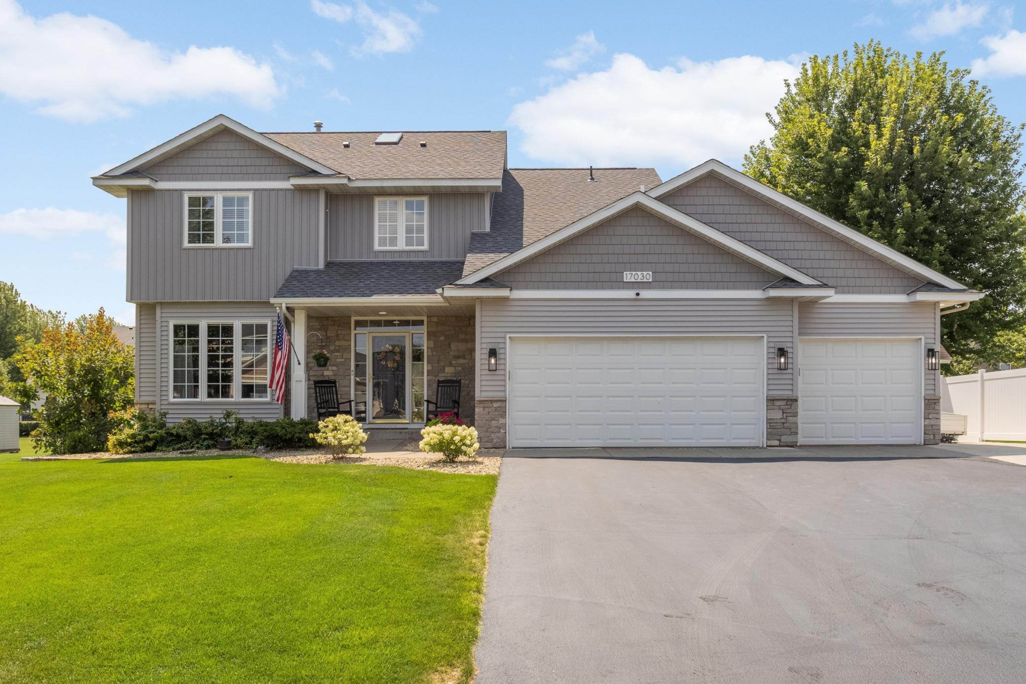 Front porch + peaked rooflines + 3-car garage + stone accents = timeless charm.