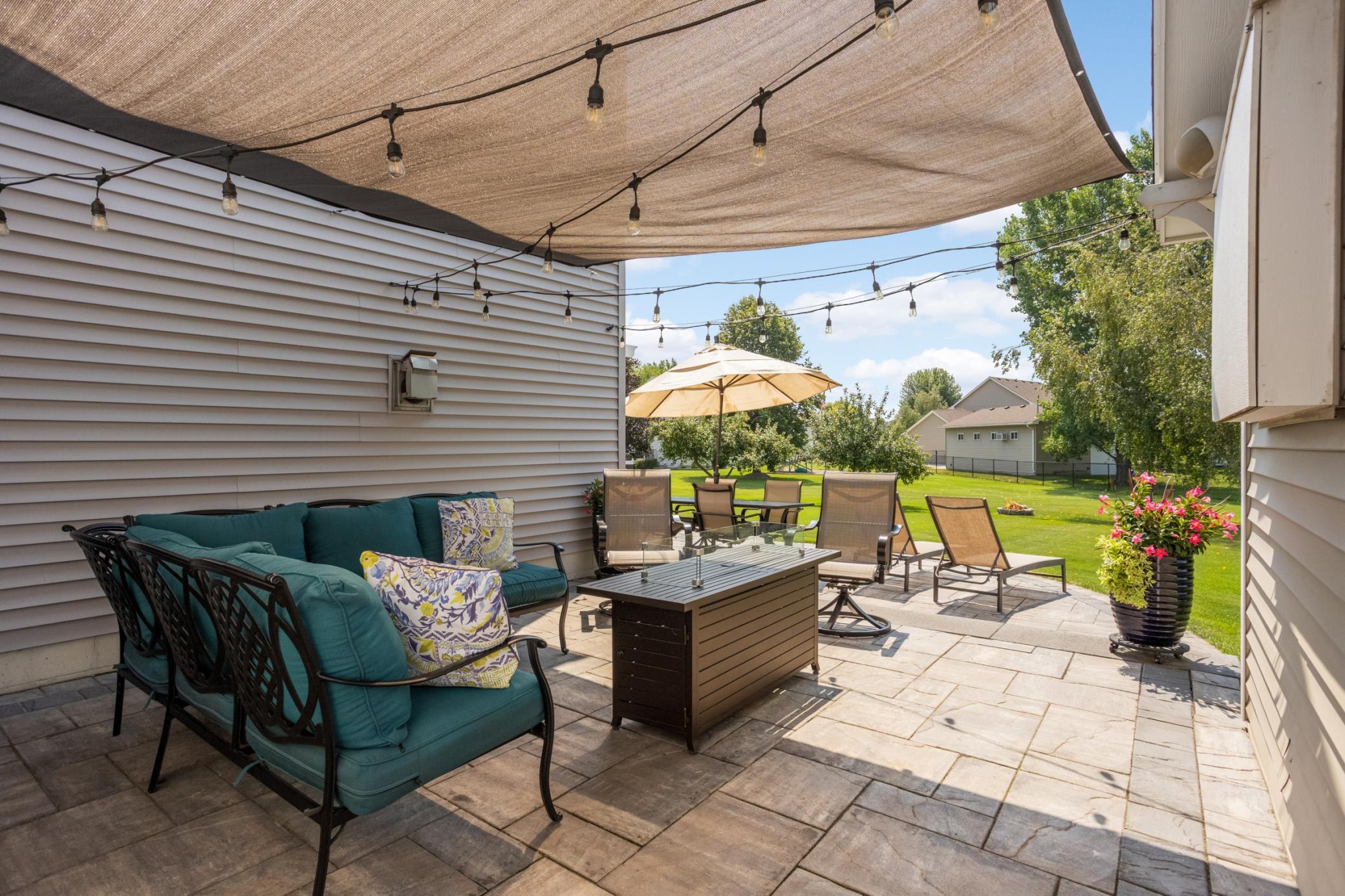 Wraparound patio connects the backyard, home & storage shed.