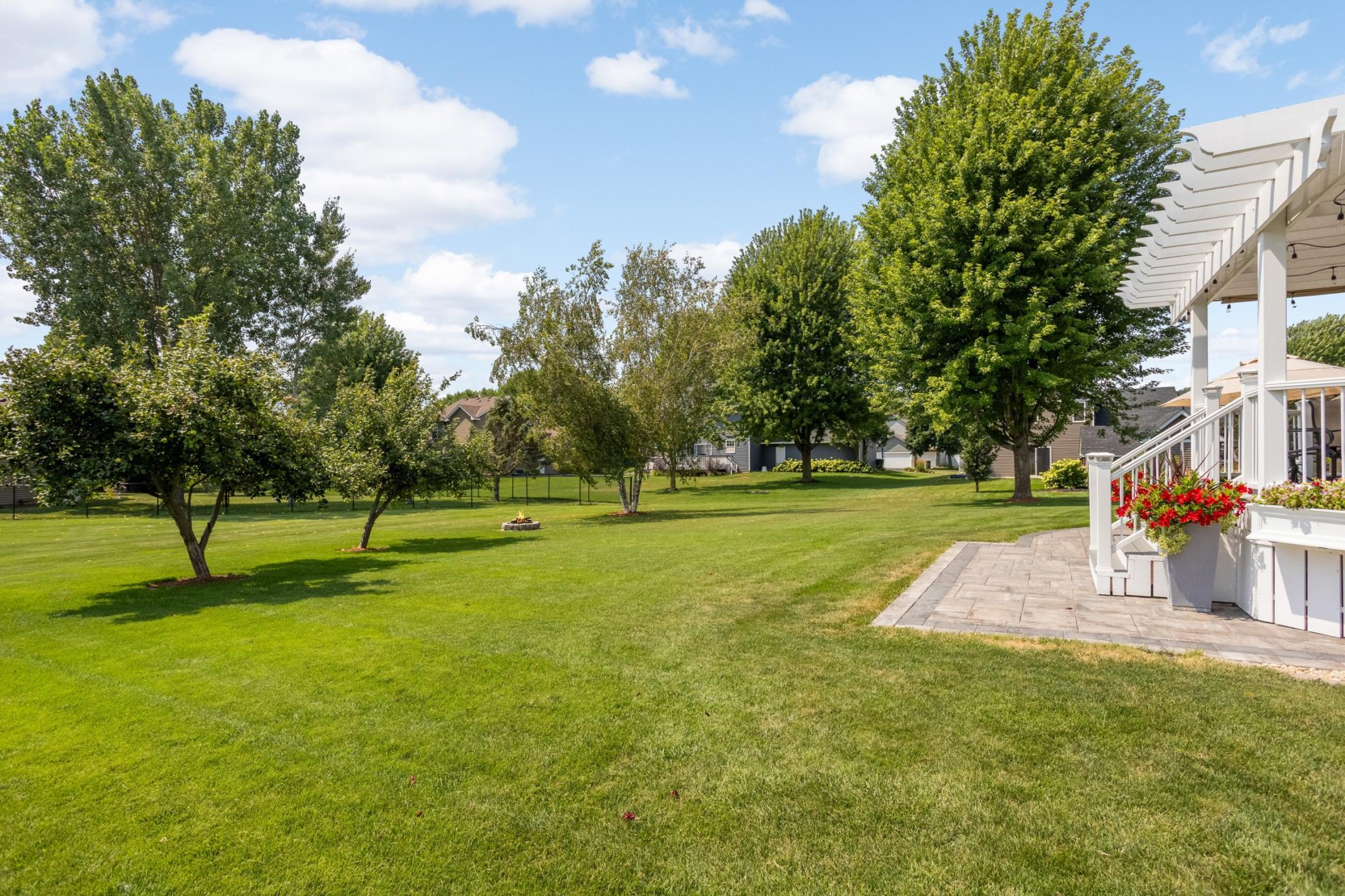 Perfectly flat, spacious & tree-lined backyard.