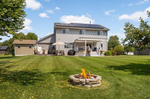 Everything you need for outdoor living: fire pit, storage shed, deck with pergola, paver patio & multiple seating and dining areas.