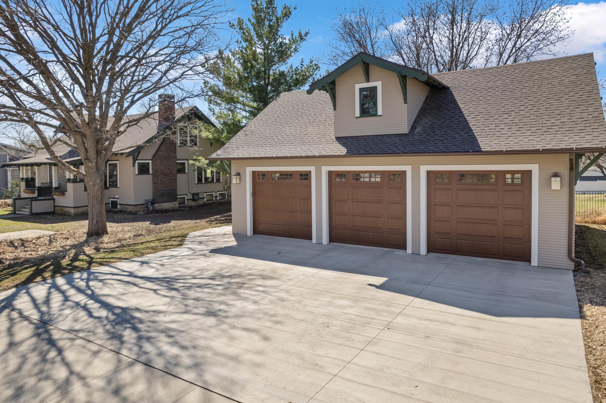 A large heated garage with air conditioning, surround sound, a projector screen, and a walk up attic