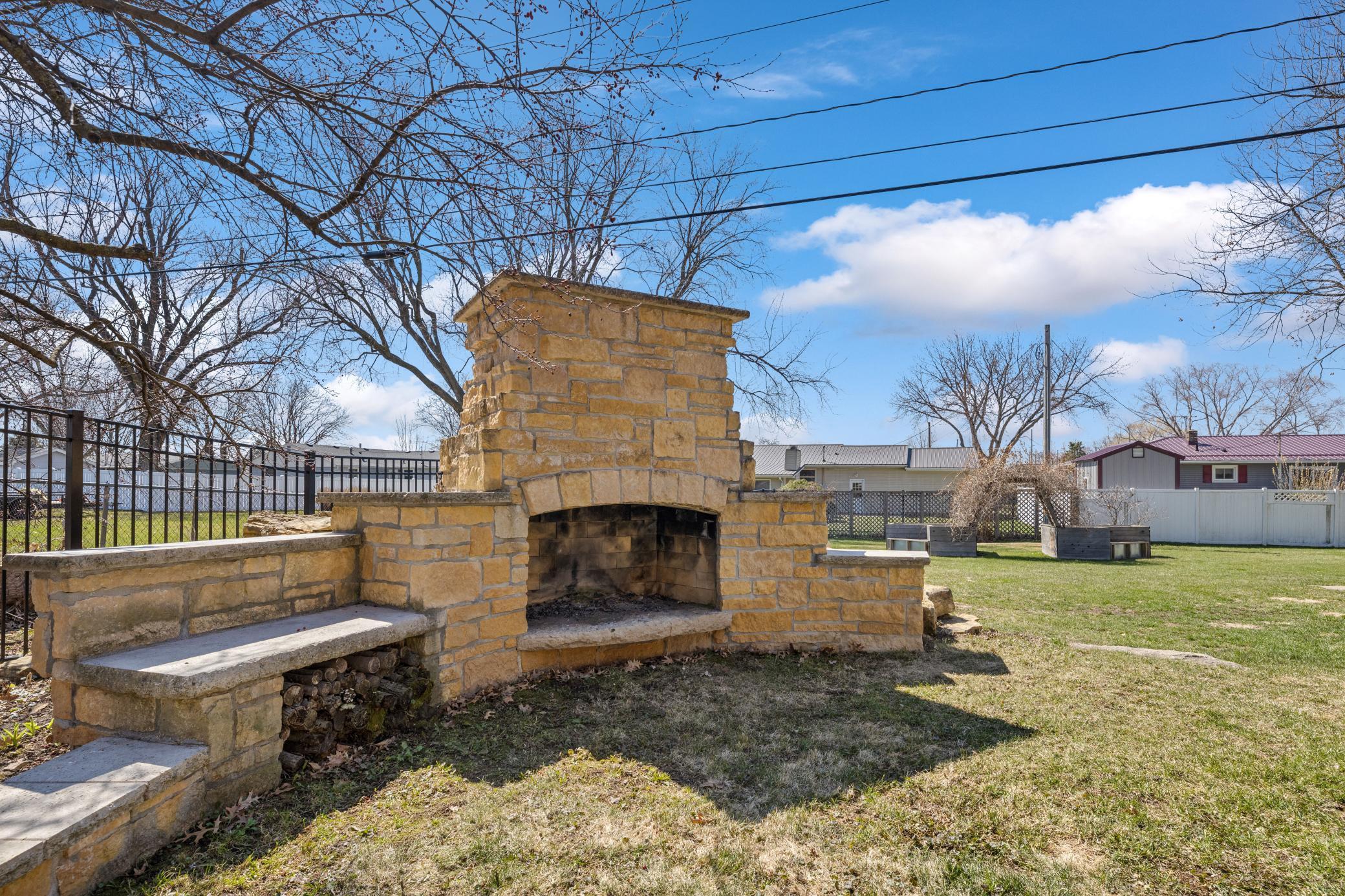 Cozy outdoor wood-burning fireplace perfect for relaxing evenings under the stars.