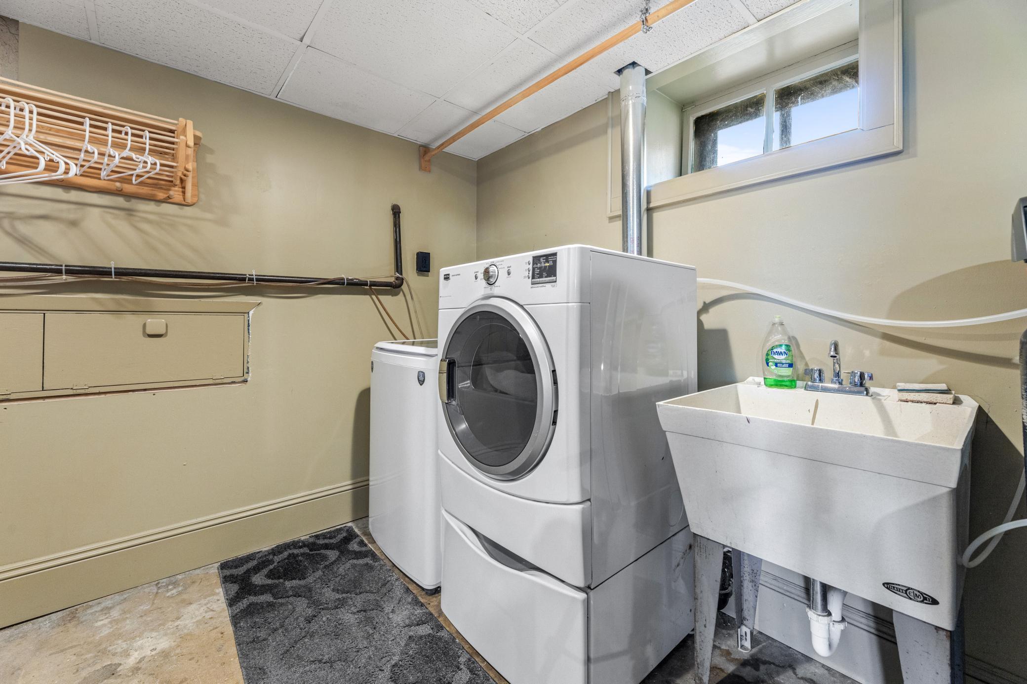 Spacious finished lower-level laundry designed for everyday ease, blending function and flow with plenty of room to work and organize.