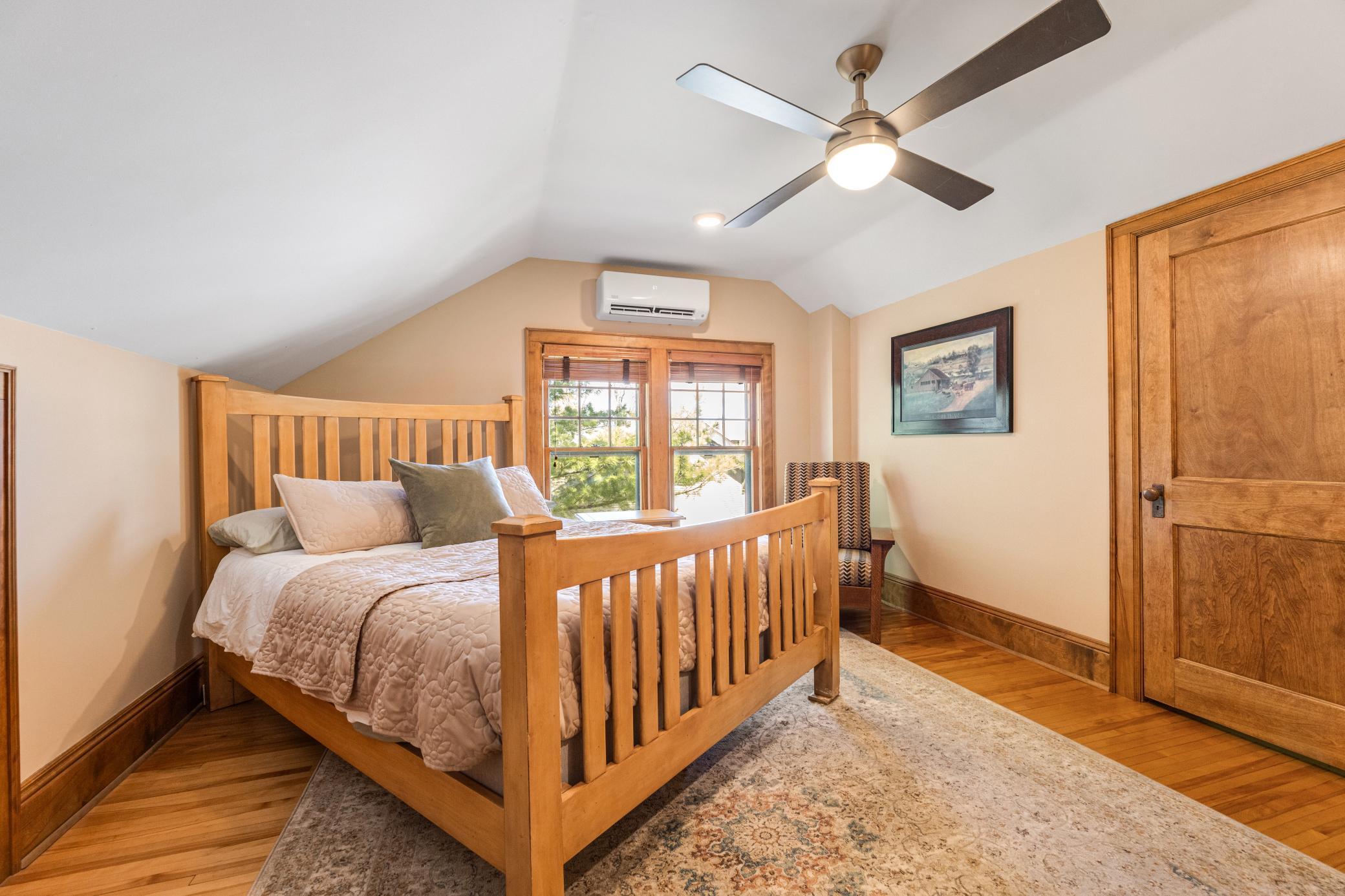charming upper bedrooms with hardwood floors and paneled doors.