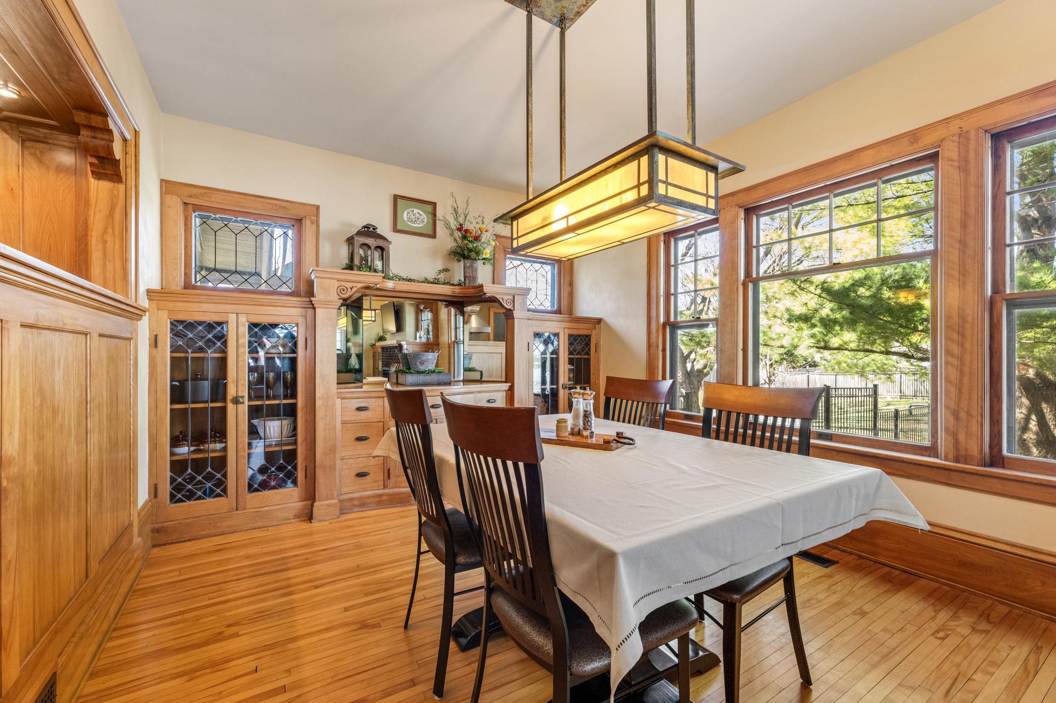 Elegant formal dining framed by leaded glass and rich built-ins that set the stage for unforgettable gatherings