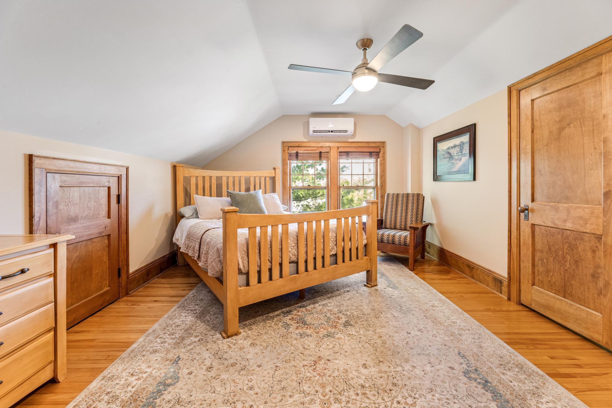 charming upper bedrooms with hardwood floors and paneled doors.