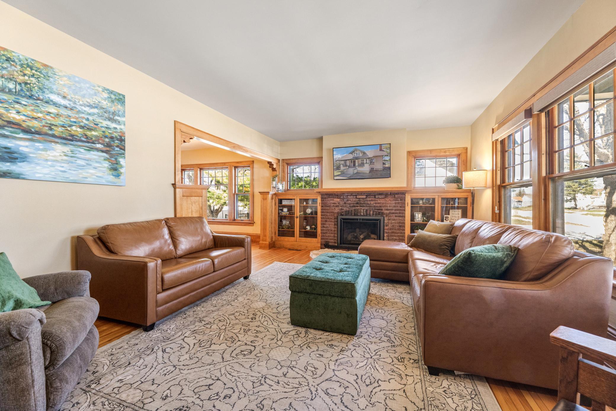 Living room with sunny windows and a beautiful gas fireplace