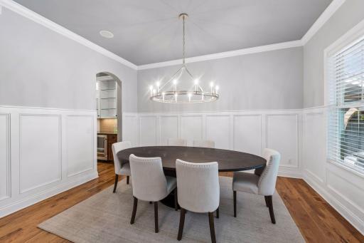 Formal dining room with beautiful wainscotting and high ceiling
