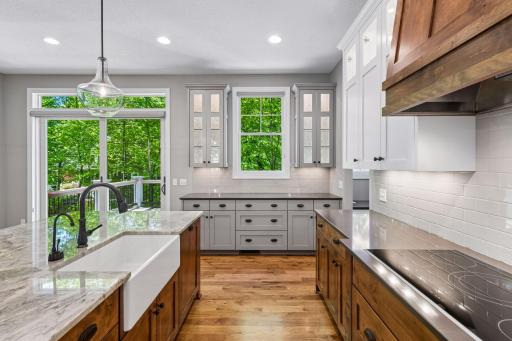 Gourmet kitchen with farmhouse sink, granite counters, and plenty of cabinetry