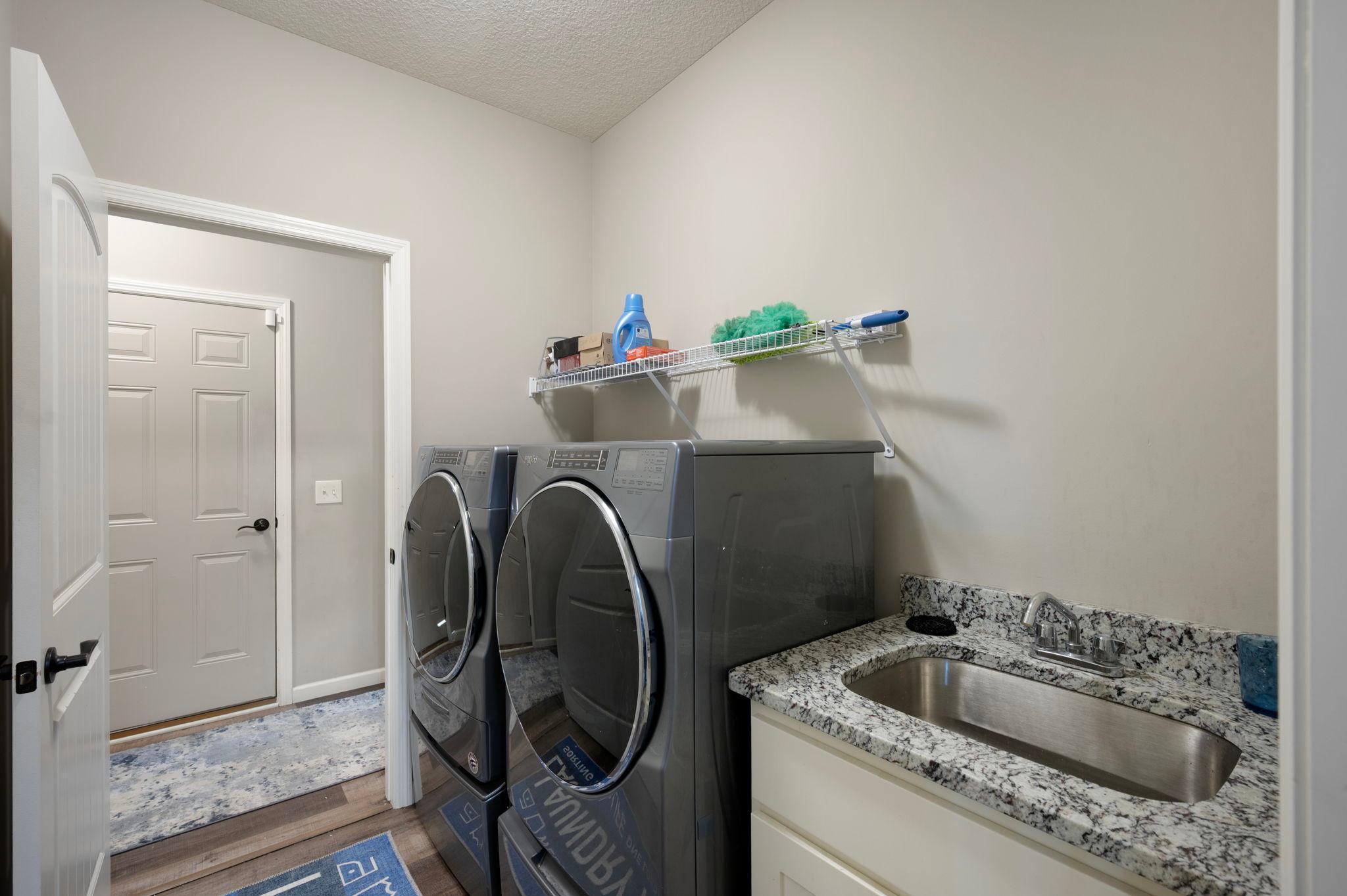 Laundry Room - View #2 with Sink (Entrance to Garage showing in background)