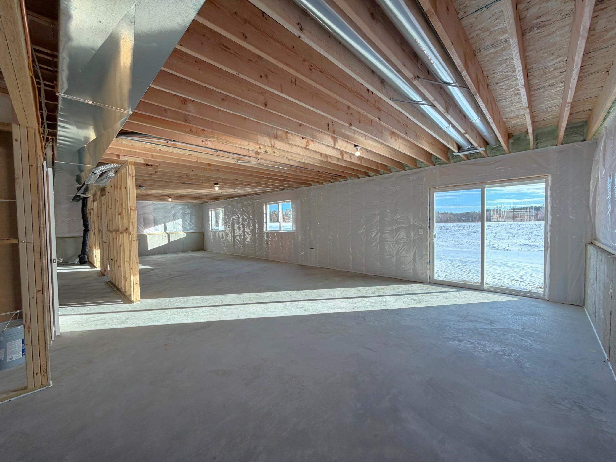 Photo is taken of another home with similar plan and finishes. Unfinished Walkout Lower Level ready for future finish. Photo may not depict actual plan, material, & finishes included in this home.