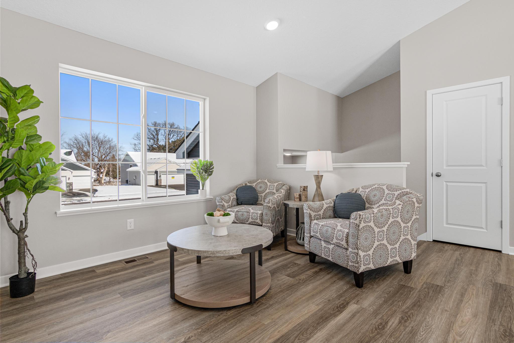 VIRTUALLY STAGED PHOTO OF A DIFFERENT HOME WITH SIMILAR PLAN & FINISHES. Great Room. Photo may not depict actual plan, material, & finishes included in this home.