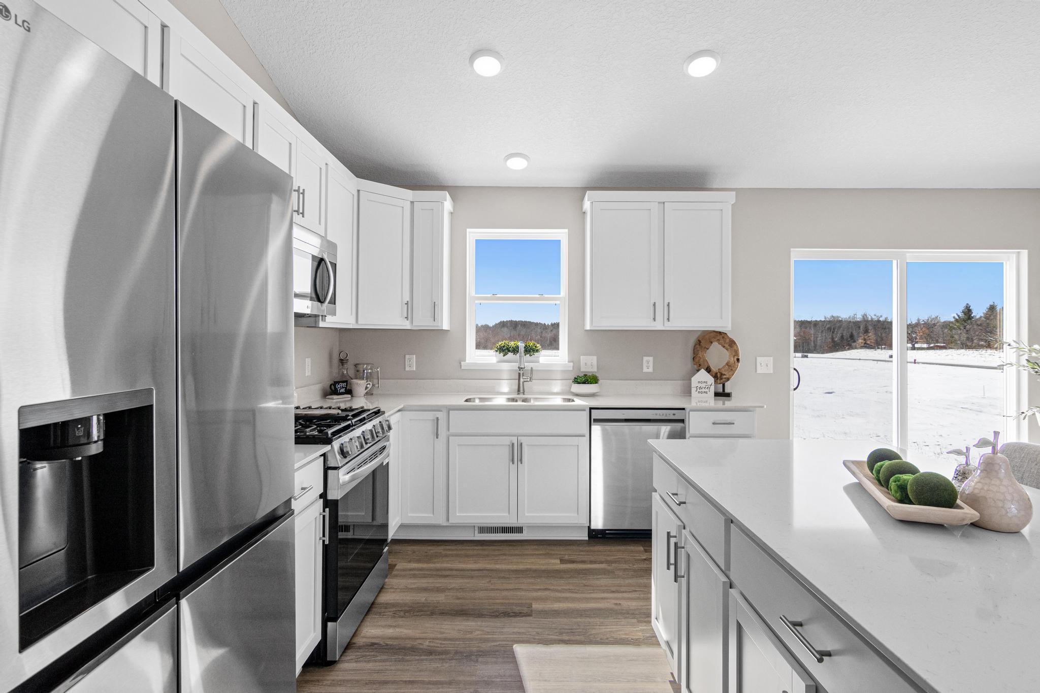 VIRTUALLY STAGED PHOTO OF A DIFFERENT HOME WITH SIMILAR PLAN & FINISHES. Kitchen. Photo may not depict actual plan, material, & finishes included in this home.