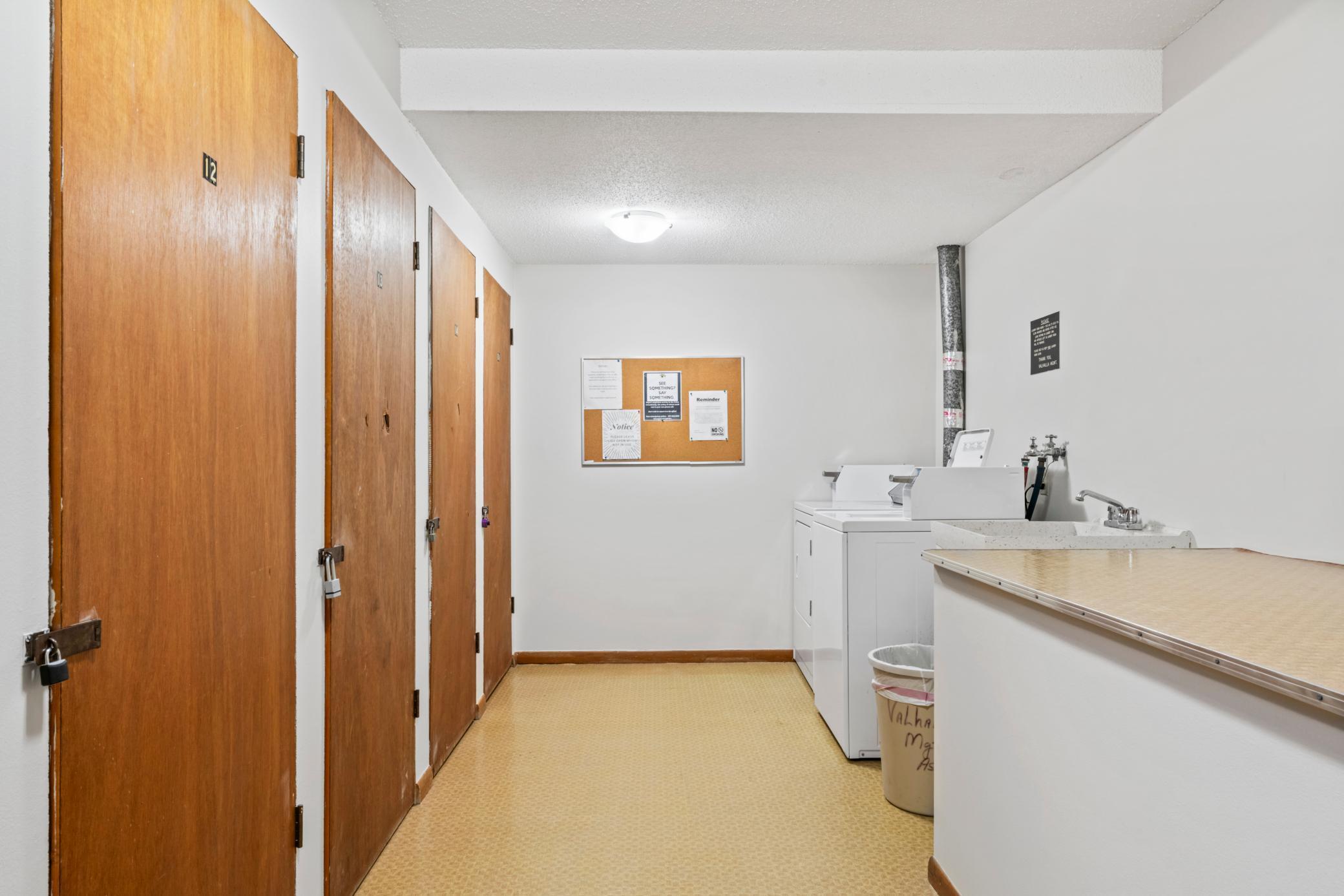 Spacious clean laundry with storage locker