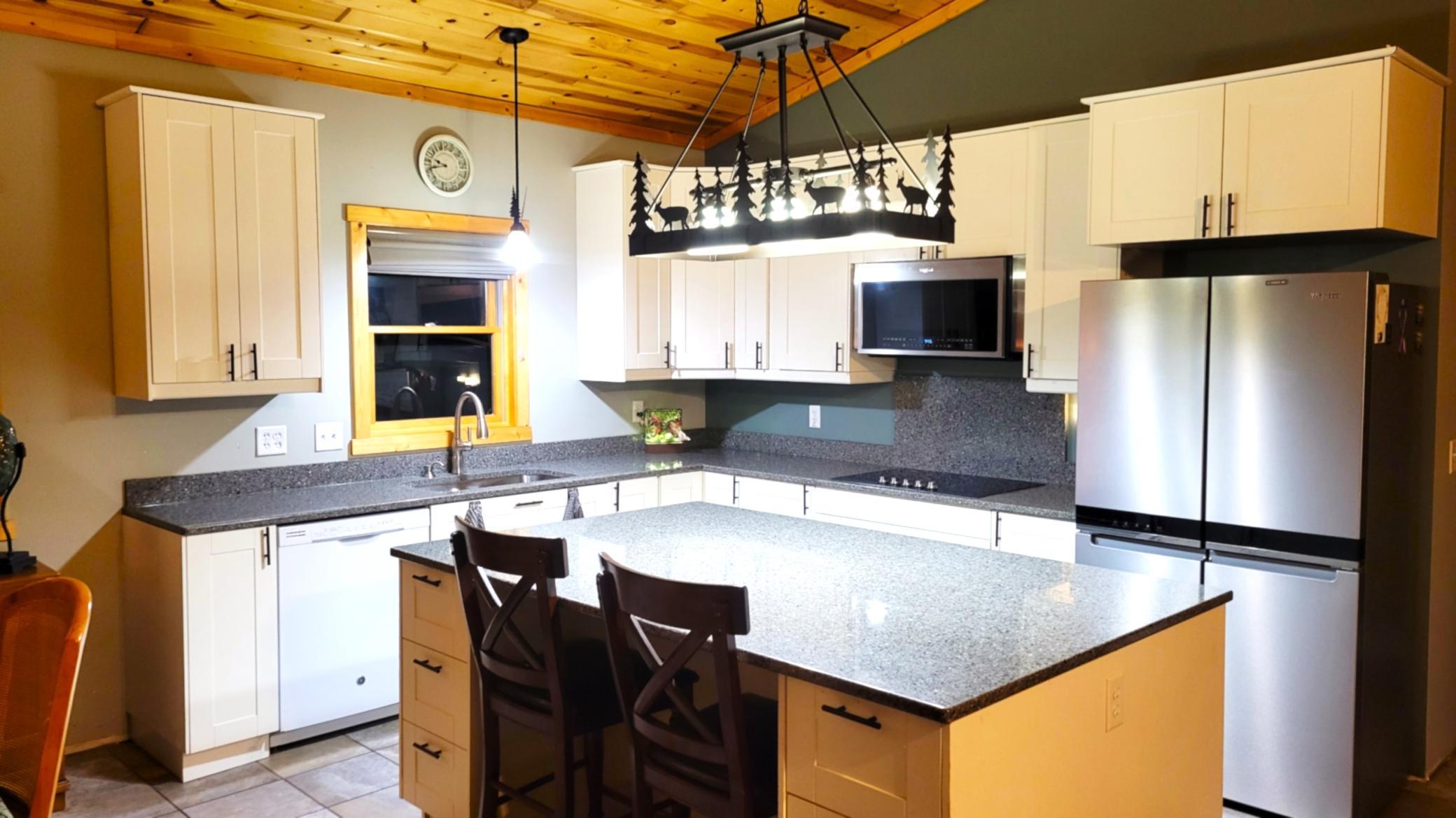 L-shaped kitchen with stone tops