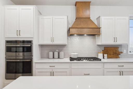 Kitchen with vented hood .( Staged photo of a model). Pic for representational purposes as finishes may be different. p -