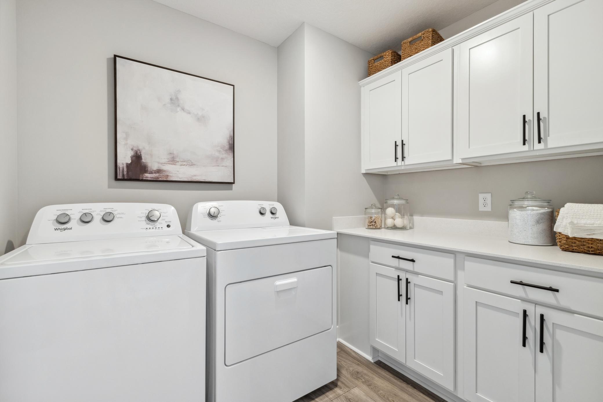 Large laundry room with cabinets.