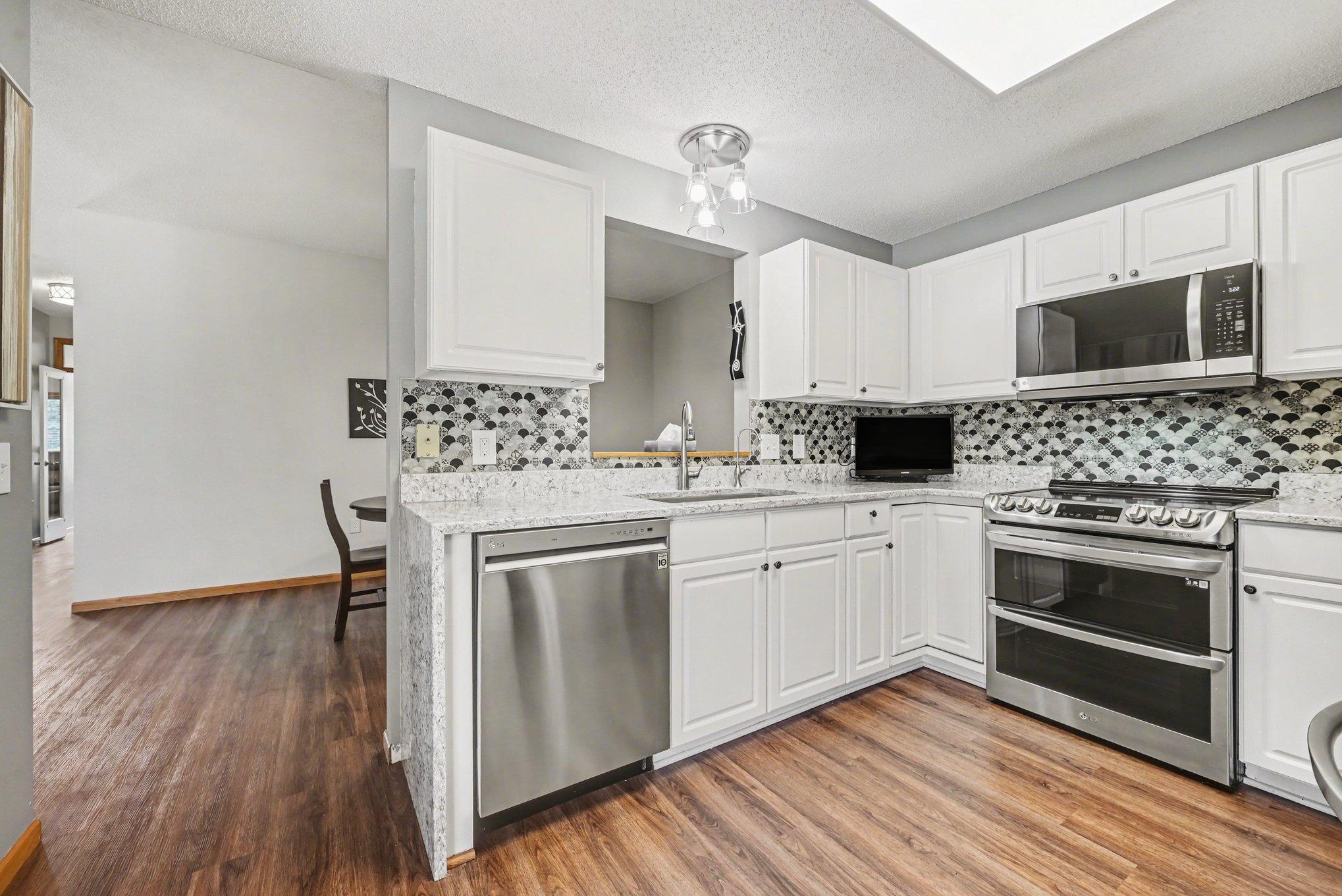 Newer Kitchen with Quartz counter top and waterfall side.