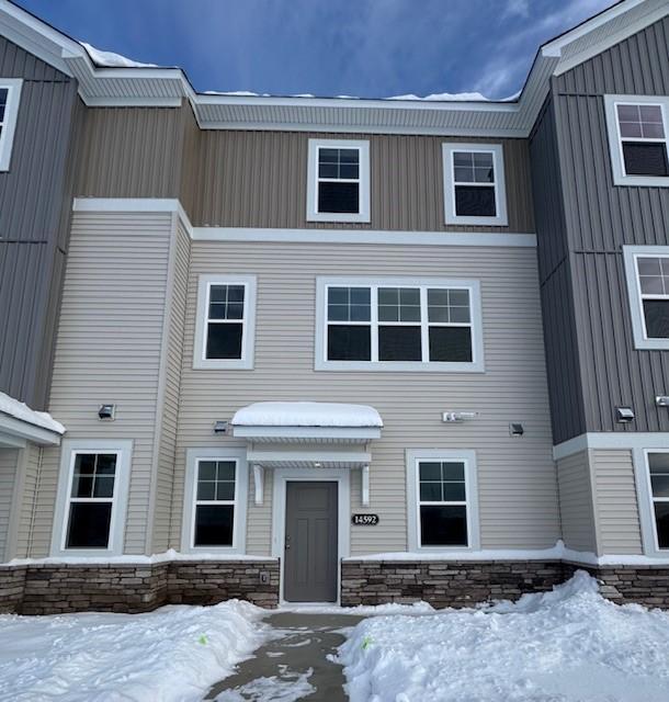 Modern design, highlighted by stone accents, charming front patio, and clean architectural lines. Expansive windows fill the home with natural light.
