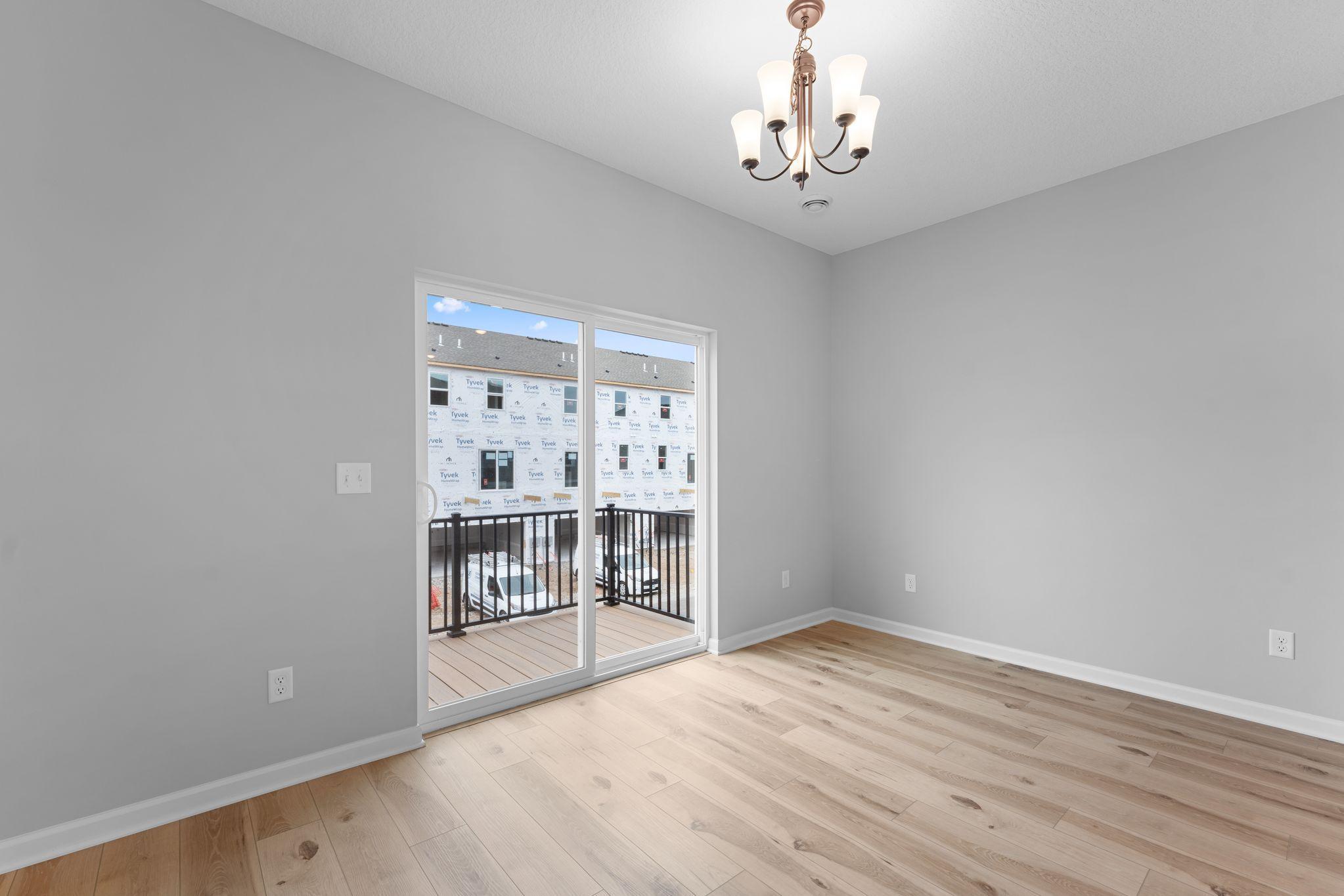 The dining area can accommodate a larger dining set and has easy access to the maintenance free deck. Similar home shown, color & finish can vary.