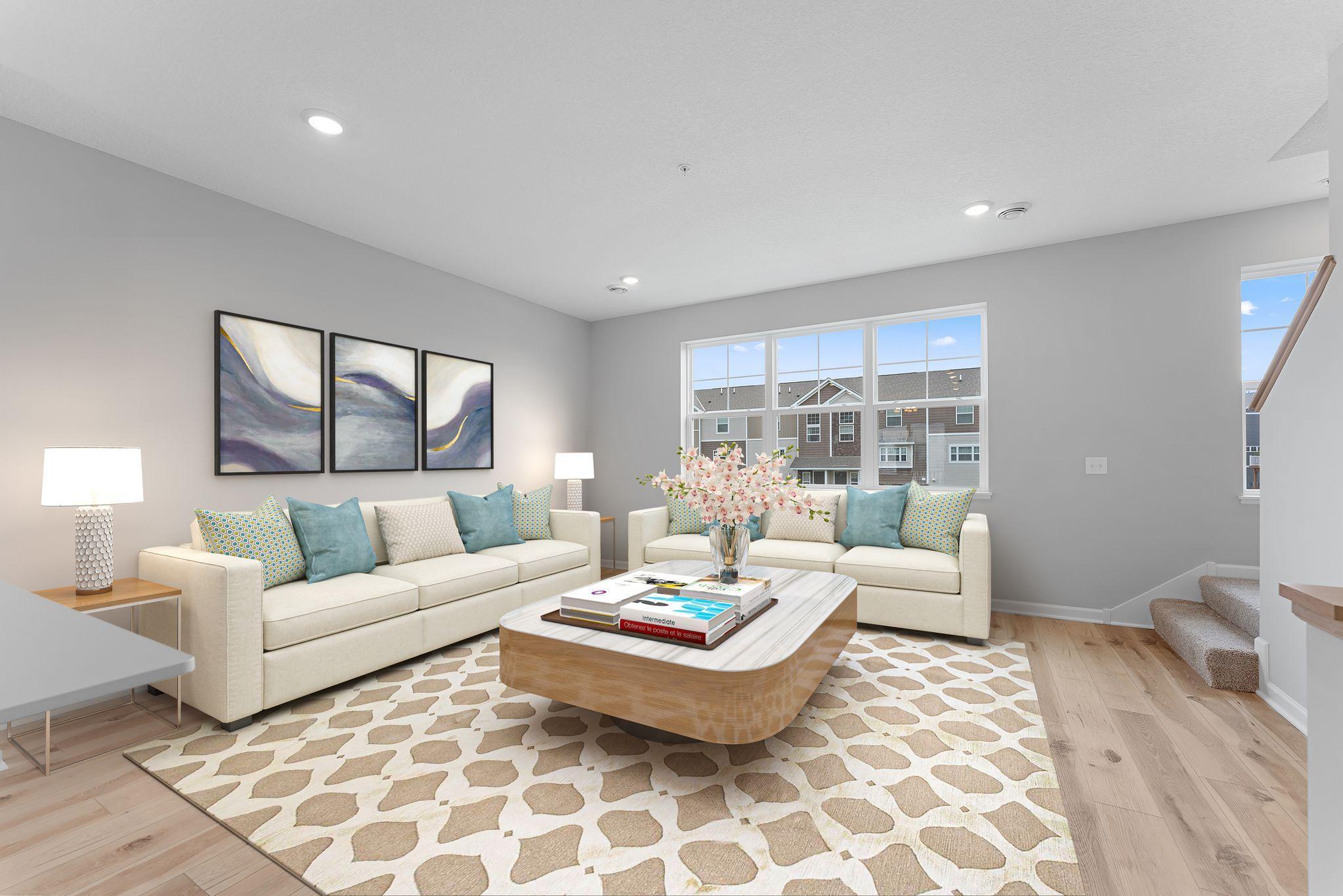 Feel the difference! Accented by the warmth of the floors, high ceilings, and large windows, the family room is a great place to gather! Similar home shown, color & finish can vary.